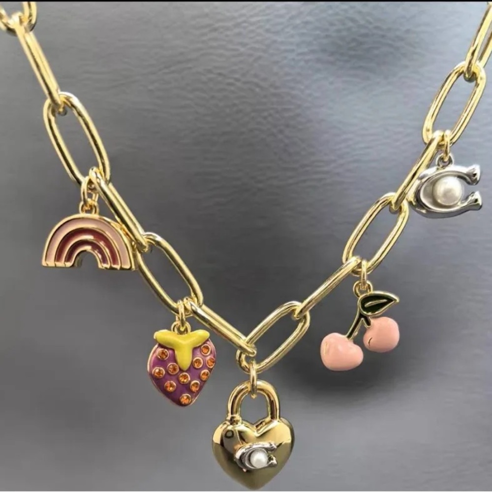 Coach charmed gold tone necklace